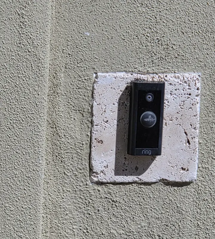 Video doorbell installed on a stucco wall by ATG